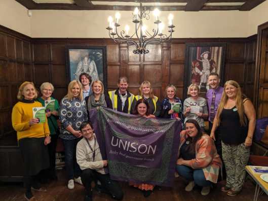 Lots of members who attended the Local Service Champions 2019 event posing with our branch banner